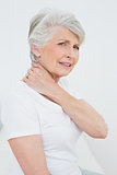 Side view portrait of a senior woman suffering from neck pain