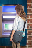 Student standing at the atm