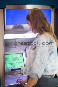 Student entering pin at the atm