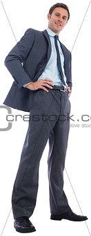 Happy businessman with hands on hips