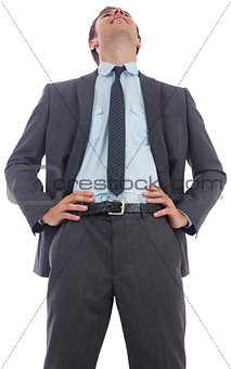 Happy businessman with hands on hips