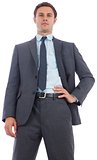 Stern businessman with hand on hip