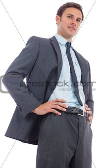 Cheerful businessman with hands on hips