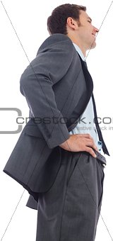 Cheerful businessman standing with hands on hips