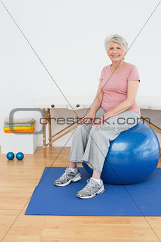 Portrait of a senior woman sitting on fitness ball