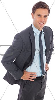 Cheerful businessman standing with hands on hips