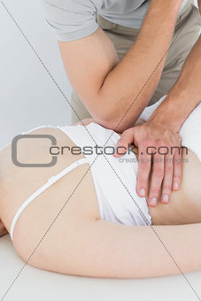 Physiotherapist massaging a woman's back