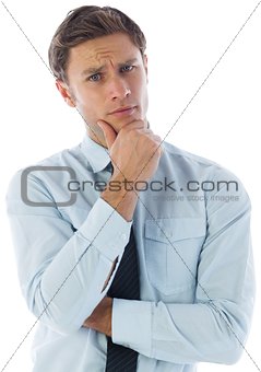 Thinking businessman with hand on chin