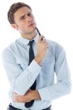 Thinking businessman holding pen