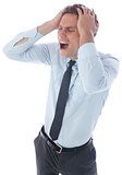 Stressed businessman with hands on head