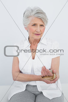 Portrait of a senior woman with hand in wrist brace