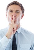 Businessman with finger on lips