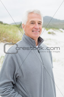 Portrait of a smiling casual senior man at beach