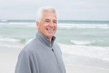 Smiling casual senior man at beach