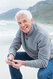 Portrait of a happy senior man relaxing at beach