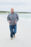 Full length of a senior man running at beach