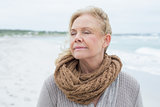 Close-up of a contemplative senior woman at beach