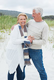 Cheerful romantic senior couple at beach