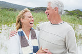 Cheerful senior couple looking at each other at beach