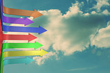 Colorful arrows pointing against sky