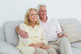 Relaxed happy senior couple with remote control