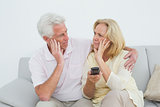 Relaxed senior couple watching television