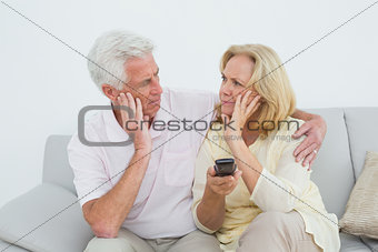 Relaxed senior couple watching television