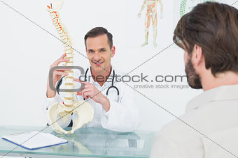 Portrait of a doctor explaining the spine to a patient
