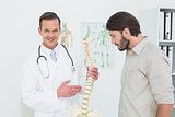 Portrait of a doctor explaining the spine to a patient