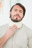 Portrait of a young man suffering from neck pain