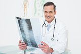Portrait of a smiling male doctor with x-ray picture