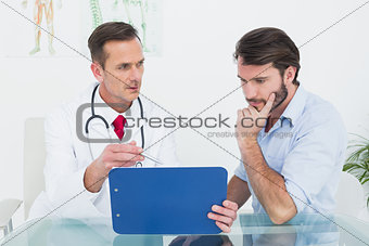 Doctor discussing reports with patient at medical office