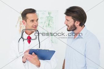 Male doctor discussing reports with patient