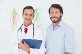 Portrait of a male doctor and patient with reports