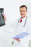 Portrait of a smiling male doctor examining x-ray