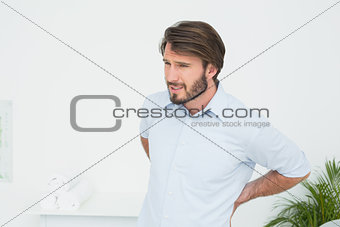 Handsome young man with back pain