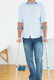 Close-up mid section of a young man with crutches
