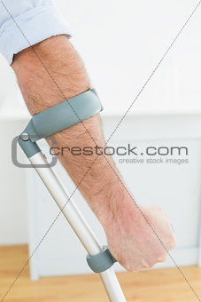 Close-up of a young man with crutch
