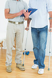 Therapist and disabled patient with reports