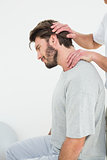 Side view of a man getting the neck adjustment done
