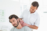 Male therapist massaging a young man's neck