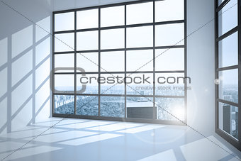 Room with large windows showing city