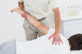 Male physiotherapist stretching a man's hand