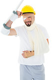 Portrait of a man in hard hat with broken hand and crutch