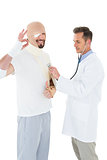 Doctor auscultating a patient tied up in bandage with stethoscope