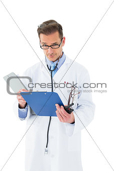 Portrait of a serious doctor with clipboard