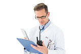 Serious doctor reading reports