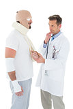 Doctor looking at patient tied up in bandage