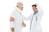 Side view of a doctor looking at patient tied up in bandage