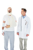 Doctor looking at a patient tied up in bandage